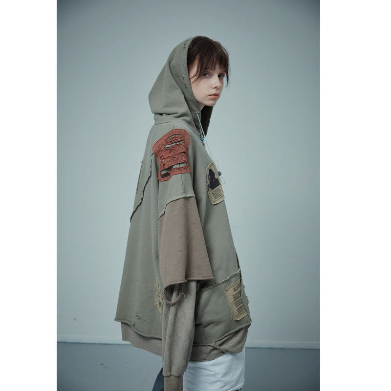 Cucitura di due finte toppe di distruzione del maglione