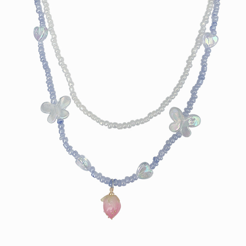 Collier double rang de perles et fleurs pour femme, un bijou raffiné et léger, empreint de luxe.